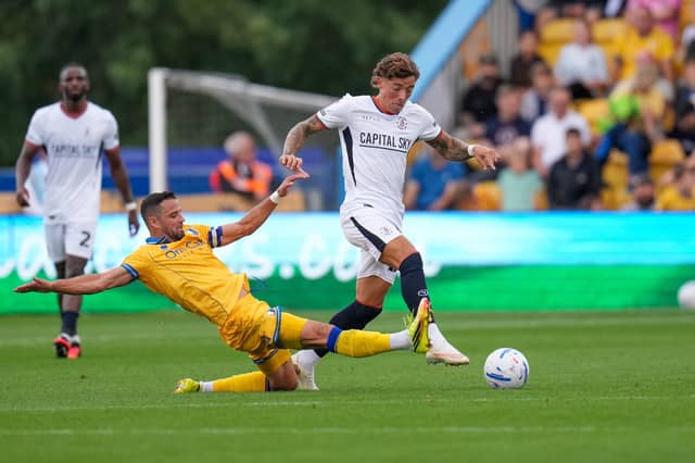 Harrison Ashby is challenged during Sunday's 5-2 defeat at Mansfield - pic: David Horn / PRiME Media Images