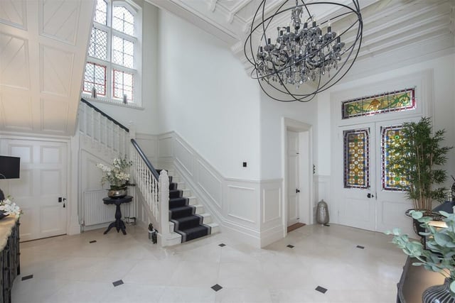 The impressive staircase leads up to the upper floors. It is light, airy and has a stained-glass door