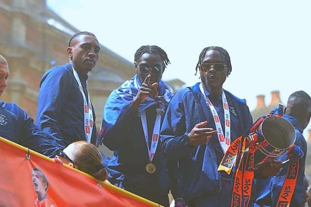 Amari'i Bell, Elijah Adebayo and Pelly-Ruddock Mpanzu with the trophy