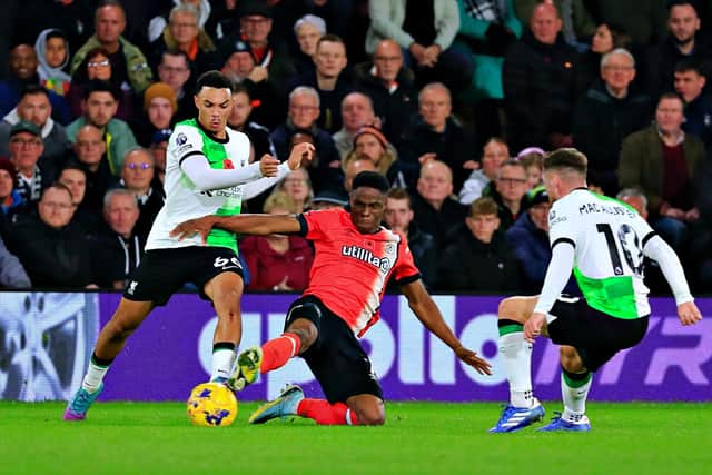 Chiedozie Ogbene slides in to try and win the ball back from Liverpool midfielder Trent Alexander-Arnold - pic: Liam Smith