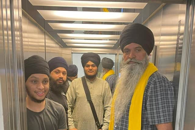 Gurdwara president Baljit Singh (right) accompanies volunteers taking food to the pop-up stall outside the council offices.