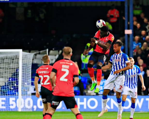 Forward Elijah Adebayo gets up to win a header against Huddersfield on Tuesday night