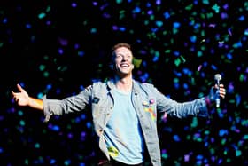 Chris Martin of Coldplay performs for fans in Auckland, New Zealand.  (Photo by Shane Wenzlick/Getty Images)