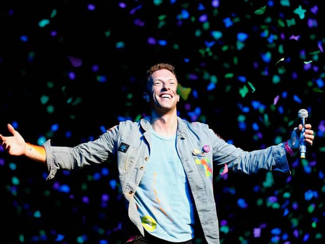 Chris Martin of Coldplay performs for fans in Auckland, New Zealand.  (Photo by Shane Wenzlick/Getty Images)