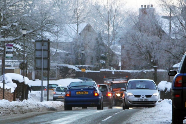 Traffic negotiates the snow piled up on the side of Welbeck Road, Bolsover, in 2010.