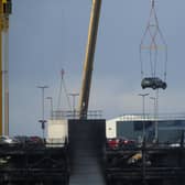 A car being removed from the fire-damaged Luton Airport car park via crane. Picture: Natalie Cummings