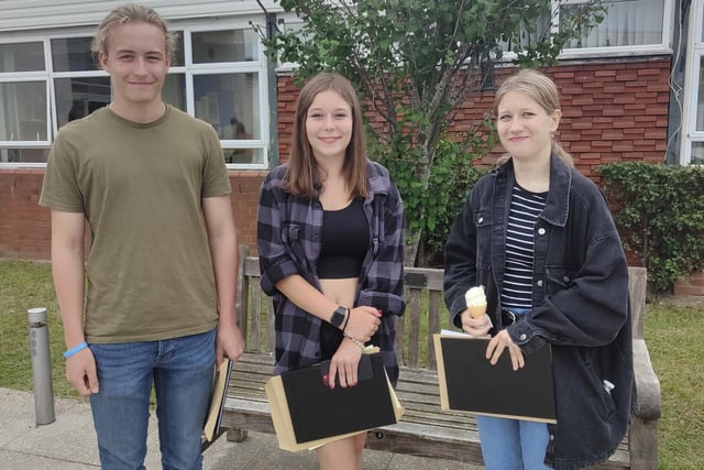 Cardinal Newman students hold their GCSE result envelopes