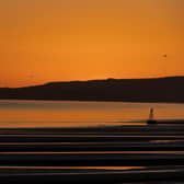 The sun sets over Camber Sands.