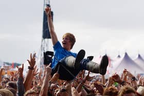 A music fan crowd surfs on a camping chair at  Reading Festival  (Photo by Simone Joyner/Getty Images)