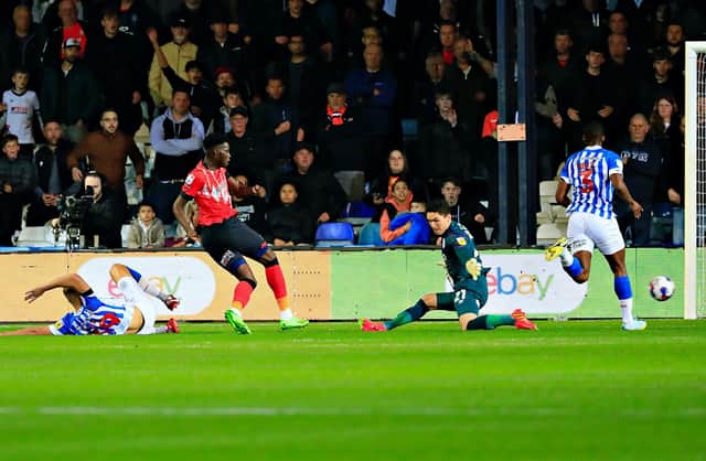 Elijah Adebayo slots home his second of the evening against Huddersfield last night