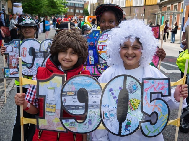 Children celebrated the town's history with banners.