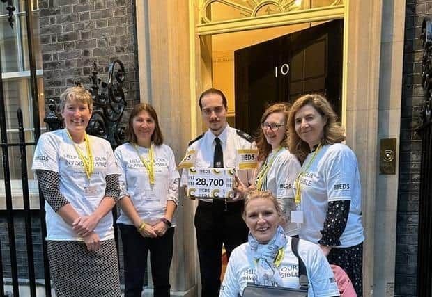 Alex hands in the petition of 28,700 signatures to Downing Street alongside EDS Support UK members. Image submitted.