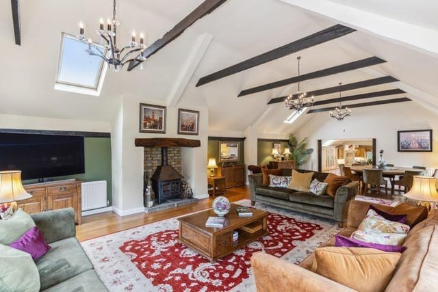 Speaking of the family and dining room, here it is! There is plenty of space for all of the family here. The room has a high-vaulted ceiling, double doors opening onto the sun terrace, pool area and garden beyond, and solid wood flooring. How pretty!