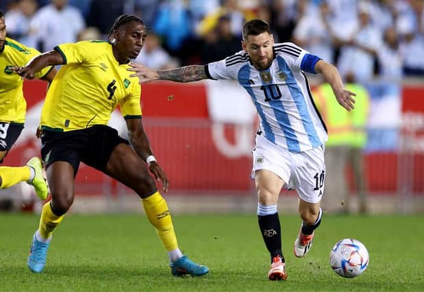 Town defender Amari'i Bell tries to win the ball back from Argentina superstar Lionel Messi - pic: Getty Images