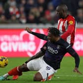 Town defender Teden Mengi was injured making this challenge against Brentford on Saturday - pic: ADRIAN DENNIS/AFP via Getty Images