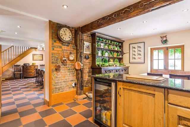 The dining room leads to the kitchen, which has wood faced cabinets and a breakfast bar