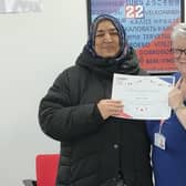 Balqis receives a certificate to celebrate her achievement from Learn Plus Us CCO, Debbie Gardiner MBE