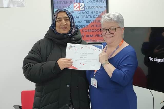 Balqis receives a certificate to celebrate her achievement from Learn Plus Us CCO, Debbie Gardiner MBE