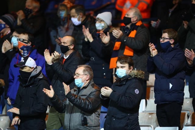 Fans of Luton Town applaud from their socially distanced seating whilst wearing a face mask ahead of the Sky Bet Championship match between Luton Town and Norwich City at Kenilworth Road on December 02, 2020.