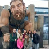 Cardinal Newman pupils pose with a statue of mythical  Irish legend Finn McCool at Belfast airport