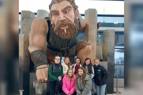 Cardinal Newman pupils pose with a statue of mythical  Irish legend Finn McCool at Belfast airport