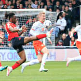 Town defender Peter Kioso makes a clearance against Blackpool