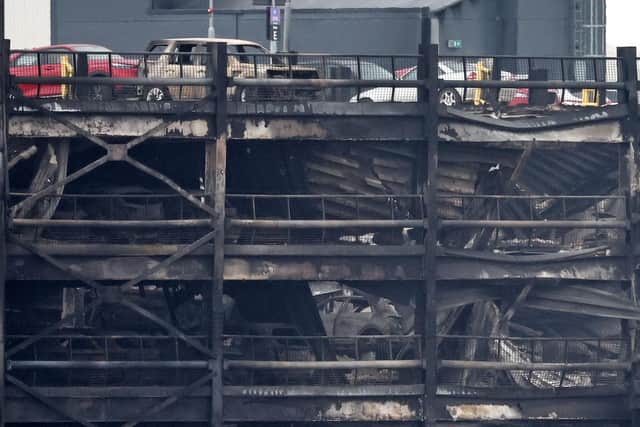 Burned out cars are pictured in a charred section of the car park, following a fire at London's Luton Airport on October 11, 2023. (Photo by HENRY NICHOLLS/AFP via Getty Images)