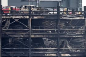 Burned out cars are pictured in a charred section of the car park, following a fire at London's Luton Airport on October 11, 2023. (Photo by HENRY NICHOLLS/AFP via Getty Images)