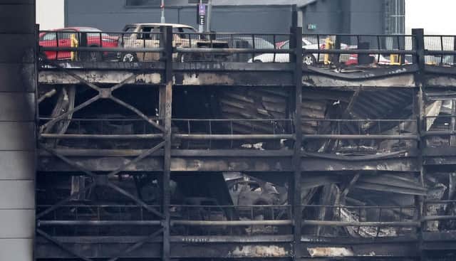 Burned out cars are pictured in a charred section of the car park, following a fire at London's Luton Airport on October 11, 2023. (Photo by HENRY NICHOLLS/AFP via Getty Images)
