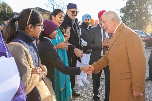 King Charles III shakes hands and speaks to congregation members after a visit to the Guru Nanak Gurdwara. (Photo by Chris Jackson/Getty Images)