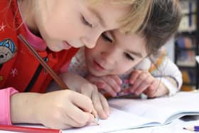 Image of two children writing by svklimkin from Pixabay