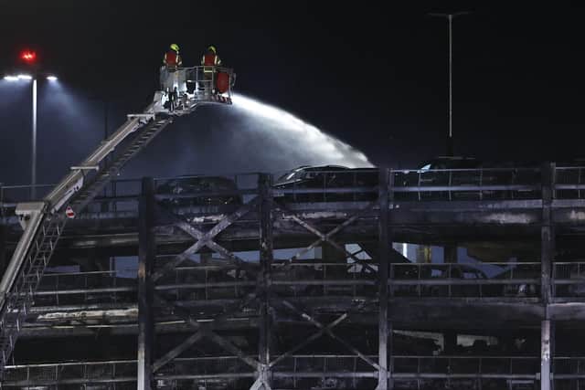 Firemen battle a blaze at London's Luton Airport which caused a partial collapse of a parking structure in Luton on October 11, 2023. Five people, including four firefighters and an airport employee, were admitted to hospital, according to the local ambulance service. (Photo by HENRY NICHOLLS / AFP) (Photo by HENRY NICHOLLS/AFP via Getty Images)