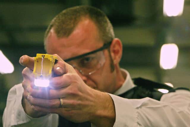 A police officer trains using a taser gun at the Metropolitan Police Specialist Training Centre. Picture: CARL DE SOUZA/AFP via Getty Images
