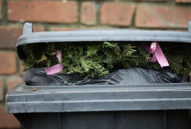 Christmas decorations sit on top of rubbish in a bin waiting to be collected. Photo by Matt Cardy/Getty Images