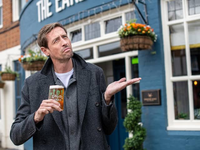 Peter Crouch with his pint. Picture: Greene King