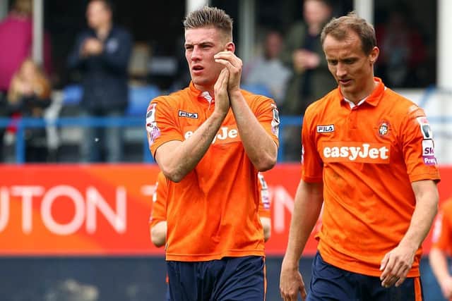 Ex-Hatter Alex Wall applauds the Town fans during his time at Luton