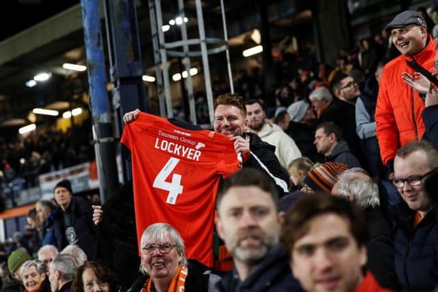 Luton Town fans hold Tom Lockyer's shirt aloft against Newcastle United this afternoon - pic: ADRIAN DENNIS/AFP via Getty Images