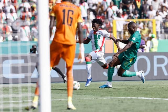 Issa Kabore is about to be brought down for Burkina Faso's match winning penalty against Mauritania - pic: KENZO TRIBOUILLARD/AFP via Getty Images