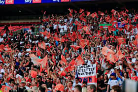 Luton Town's supporters celebrate winning at Wembley