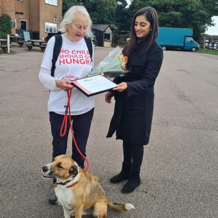 Maggie and Kiwi, receiving a certificate from Dharmi Patel of Luton Foodbank.