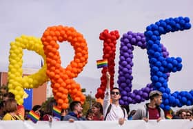 People hold balloons forming the word "Pride" during the Gay Pride parade in Pristina on October 10, 2019. - Hundreds of Kosovo people marched along the main street during a Gay parade demanding "freedom" and "equal rights" in the patriarchal and Muslim majority country with little tolerant views on sexuality. (Photo by Armend NIMANI / AFP) (Photo by ARMEND NIMANI/AFP via Getty Images)