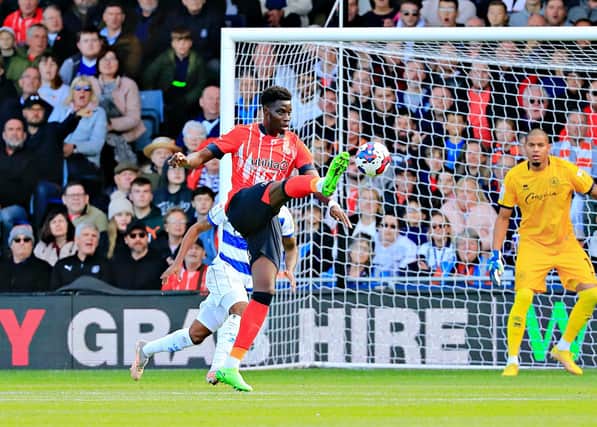 Town striker Elijah Adebayo holds the ball up against QPR