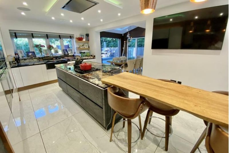 A large modern kitchen with a wooden table and chairs