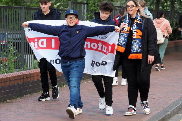 Hopeful fans carrying a flag to the match