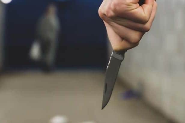 File picture of a person holding a knife