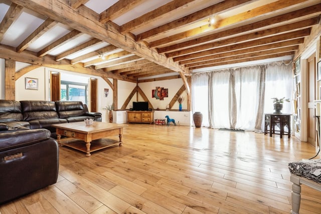 The living room has original features like the traditional oak beams
