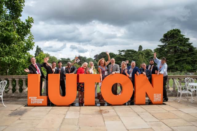 Supporters of Step Forward Luton pose with giant letters (Picture: Kate Elizabeth Photography)