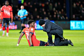 Town striker Elijah Adebayo receives treatment during the Boxing Day win over Norwich City