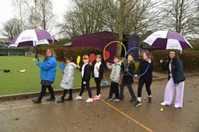 Pupils at Ardley Hill Academy holding the new sports equipment donated by Taylor Wimpey South Midlands.