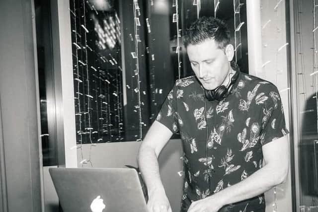 Jon Boyle working as a DJ
